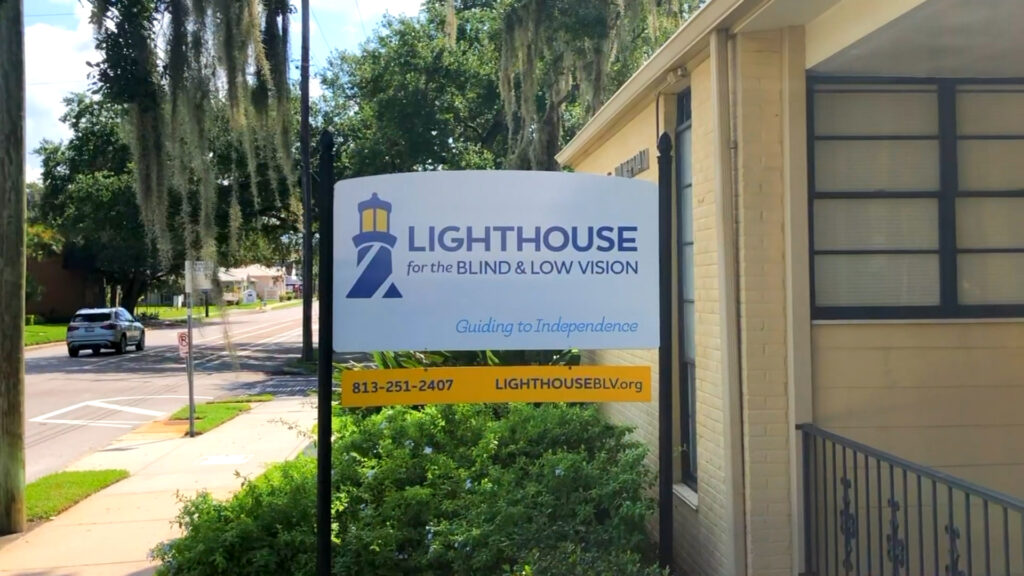 A photo of the Lighthouse for the Blind & Low Vision sign in front of the Tampa office.